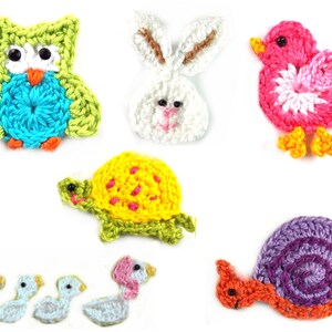 May include: A collection of crochet animal appliques including a lime green and blue owl, a white rabbit, a pink bird, a yellow turtle, a purple snail, and a row of four small white and blue birds, all crafted with detailed yarn stitching.