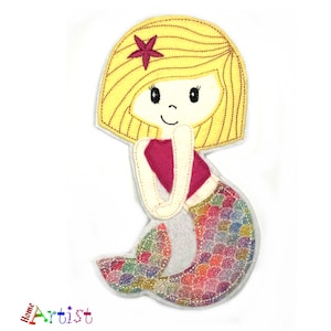 May include: A felt appliqué of a mermaid with blonde hair, a pink top, and a colourful, iridescent tail. The mermaid has a red star on her head.