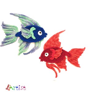 May include: Two crocheted fish, one blue and green and one red. Both fish are facing right and have a white eye with a black pupil.