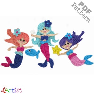 May include: Three crocheted mermaid figures with colorful tails, hair, and flowers. The mermaids are holding a starfish, a fish, and a seashell.