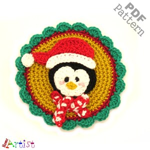May include: Crochet pattern for a penguin wearing a red and white Santa hat and a red and white scarf. The pattern is in a circle with a green, red, and gold border.