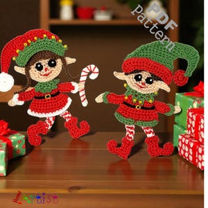 May include: Two crocheted elf figures in red and green outfits, with matching hats and shoes. One elf holds a candy cane. The figures have brown hair and smiling faces. The image includes the text "PDF Pattern".