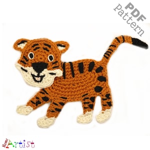 May include: A crocheted tiger applique in orange, black, and cream. The tiger features black stripes, a cream-coloured face and paws, and a smiling expression. The words "PDF pattern" are visible.
