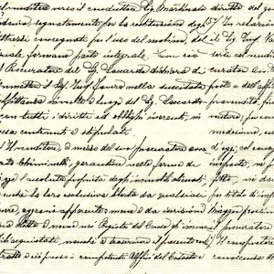 May include: A close-up of a vintage document with handwritten text in black ink. The paper has aged, showing signs of wear and tear. The script appears to be in Italian, with elegant cursive writing.