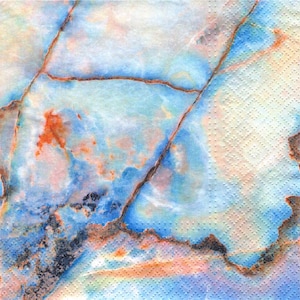 May include: A close-up of a paper napkin with a marble-like pattern. The design features a blend of blue, orange, and white hues with brown vein-like lines. The napkin has a textured, dotted surface.