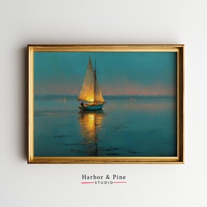 May include: A framed print of a sailboat on the water at dusk. The boat has a white sail and is reflected in the water. The sky is a gradient of blue and orange. The frame is gold. The text "Harbor & Pine - STUDIO" is at the bottom.