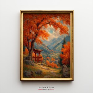 May include: Framed artwork depicting a vibrant autumn landscape. A red torii gate stands near a tree with fiery orange leaves. The background shows rolling hills and mountains under a cloudy sky. The artwork is framed in a gold-colored frame. The text "Harbor & Pine STUDIO" is at the bottom.