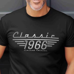 May include: Black t-shirt with the text "Classic 1966 Limited Edition" in silver lettering. The design features the word "Classic" above the year "1966" with horizontal lines. The shirt is short-sleeved.