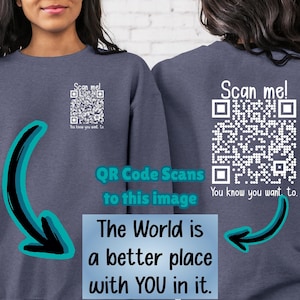 May include: A dark blue sweatshirt with a white QR code on the front and back. The text "Scan me! You know you want to." is printed below the QR code on both sides. The text "The World is a better place with YOU in it." is printed on the front of the sweatshirt.