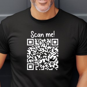 May include: A black t-shirt with a white QR code and the text "Scan me!" printed on the front.