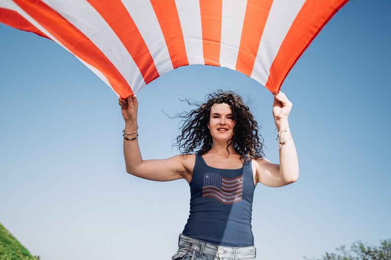 American flag in rhinestones on a navy tank top.