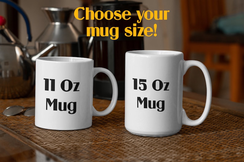 May include: Two white ceramic mugs with black text. The mug on the left says "11 Oz Mug" and the mug on the right says "15 Oz Mug".