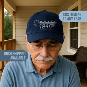 May include: A navy blue baseball cap with the word "Classic" above the year "1946" in silver lettering. The phrase "Limited Edition" is below the year. The cap is worn by a person.