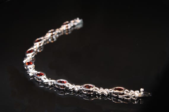 Vintage 'Hugs and Kisses" bracelet in sterling silver with oval garnets, 7 3/8" long