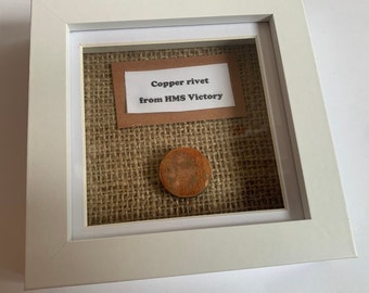 Copper rivet taken from HMS Victory presented in a frame