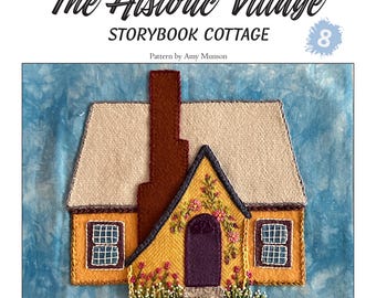 May include: A wool applique block featuring a charming yellow cottage with a brown chimney and roof. The cottage has a purple door, floral accents, and two windows. The text "The Historic Village Storybook Cottage" is at the top.