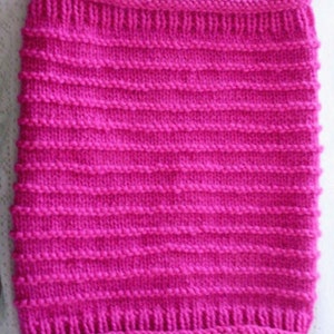 May include: A bright pink knitted fabric with a ribbed texture. The fabric is soft and smooth, and it has a subtle sheen.