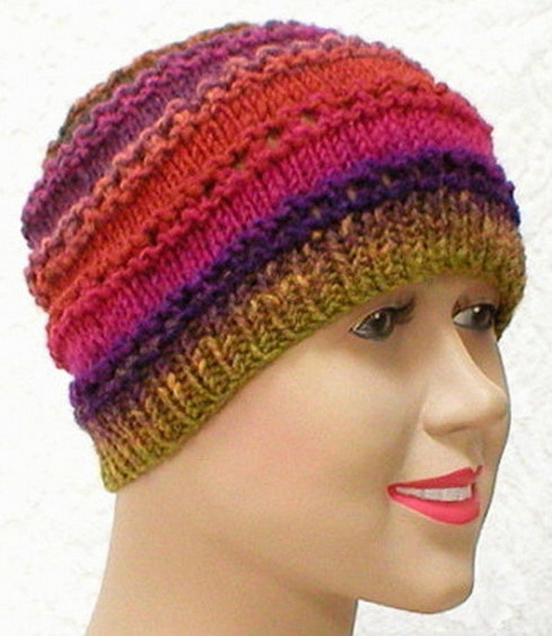 May include: A colorful knitted hat with a multi-colored striped pattern in shades of orange, pink, purple, and green.