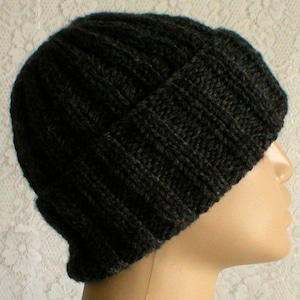 May include: A dark grey knitted beanie with a ribbed texture.