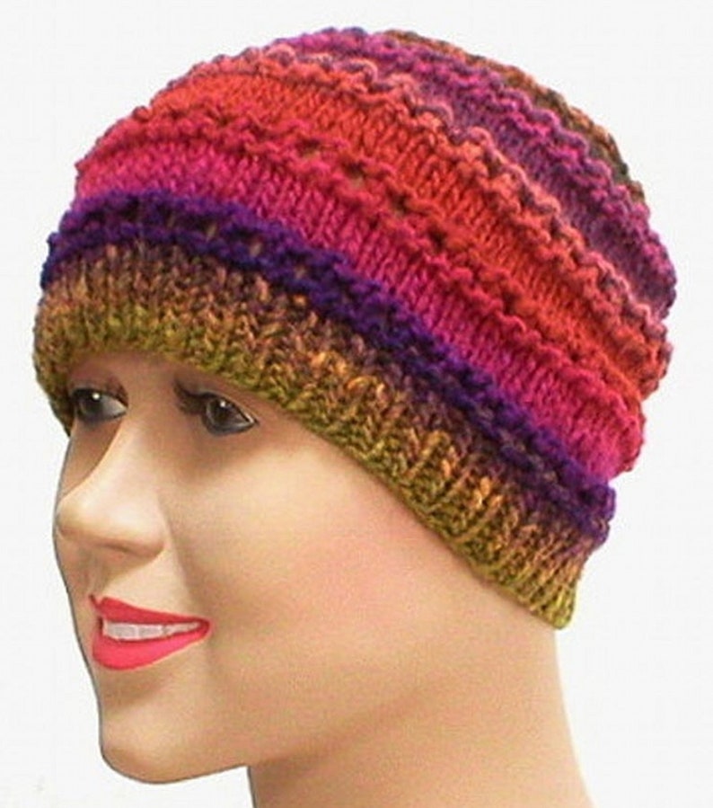 May include: A multi-colored knitted beanie hat with a textured pattern. The hat is made with a gradient of colors, including red, orange, yellow, green, purple, and blue.