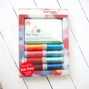 May include: A box of Gutermann Sulky Tear Easy embroidery thread in a variety of colours, including orange, red, blue, and green. The box includes a 50 x 50 cm piece of Tear Easy fabric for free.