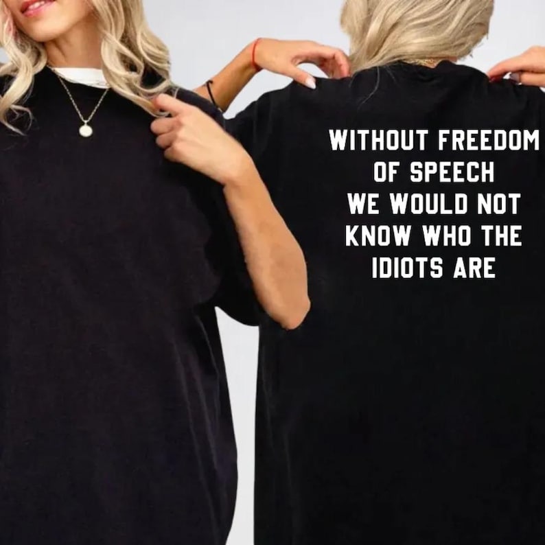 two people wearing black t-shirts with the text "Without freedom of speech we would not know who the Idiots are" printed on them.