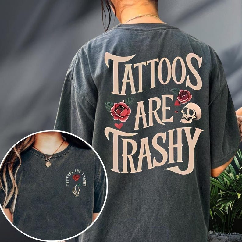 A person wearing a gray t-shirt with the text "Tattoos are Trashy" printed on it.