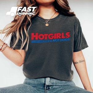 a woman wearing a hot girls love hot dogs t - shirt