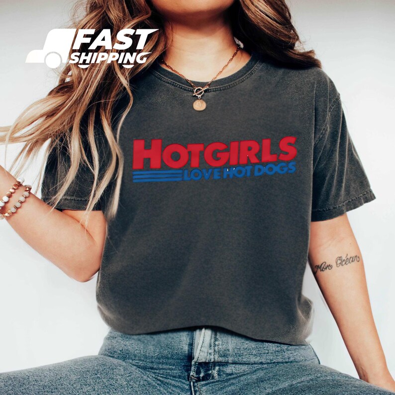 a woman wearing a hot girls love hot dogs t - shirt