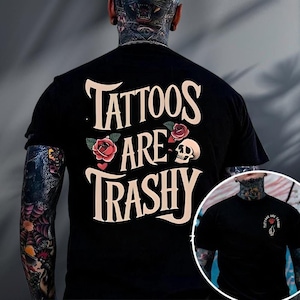 A person wearing a black t-shirt with the text "Tattoos are Trashy" printed on it.