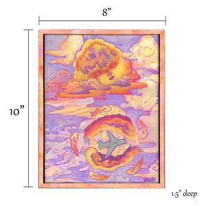May include: A rectangular framed artwork measuring 8 inches wide by 10 inches high and 1.5 inches deep. The print features a stylized yellow cloud with a human face, a gray airplane flying through swirling orange and purple clouds, and a signature.