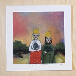 May include: A square art print featuring two figures wearing yellow crowns against a sunset sky. One figure wears a white top and red skirt holding a moon, while the other wears a green dress holding a star-filled sphere. Text reads: They held the moon and stars.