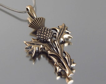 May include: A silver chain necklace with a bronze pendant featuring a detailed thistle design. The thistle is a traditional Scottish symbol.