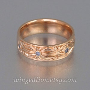 The COUNT mens wedding band in 14K rose gold with alexandrites