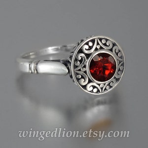 The SECRET DELIGHT silver ring with red Garnet and white sapphires