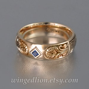 May include: A gold band ring with intricate carvings and a small blue sapphire gemstone. The ring is engraved with the text "RJC 14K".