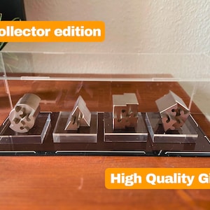 May include: A clear acrylic display case with a black base, showcasing five silver metal puzzle pieces. The case has a label that reads "Collector edition" and "High Quality Gift".