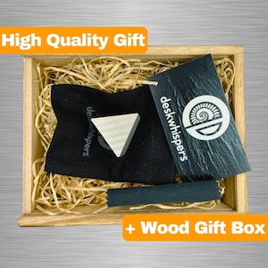 May include: A wooden gift box containing a black pouch with a small, white, triangular object. The pouch has the text "deskwhispers" printed on it. The box has the text "+ Wood Gift Box" printed on it.