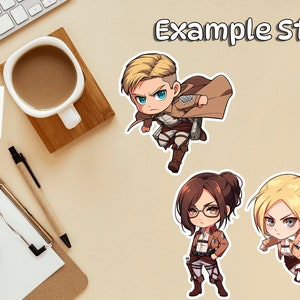 May include: Four cartoon character stickers featuring characters from the anime Attack on Titan. The characters are Eren Yeager, Mikasa Ackerman, Armin Arlert, and Levi Ackerman. The stickers are printed on white glossy paper and are approximately 3 inches in diameter.