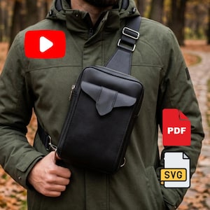 May include: A black leather crossbody bag with a flap pocket and adjustable strap. The bag is worn over the shoulder and across the chest. The person is wearing a green jacket. The background is blurred with fall foliage.