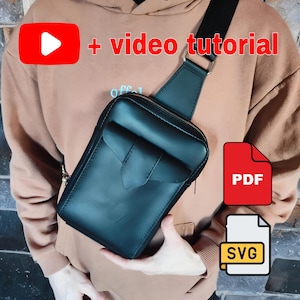 May include: Black leather crossbody bag with a flap pocket and a zipper closure. The bag has a black adjustable strap. The image includes the text "+ video tutorial", "PDF", and "SVG".