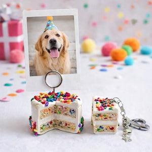 May include: A white ceramic mug with a black handle and the text "But First, Coffee" in a black, handwritten-style font. The mug is on a white surface.