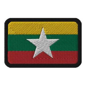 Op de afbeelding: Geborduurde patch met de vlag van Myanmar. Het ontwerp bevat horizontale strepen in geel, groen en rood, met een grote witte ster in het midden. De patch heeft een zwarte rand.