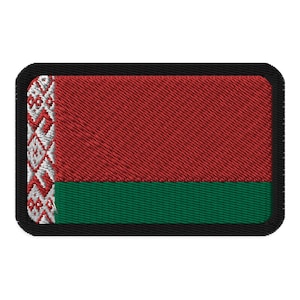 May include: A red and green embroidered patch with a white and gray pattern on the left side. The patch is surrounded by a black border.