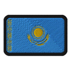 May include: A blue embroidered patch featuring a yellow sun and stylised eagle wings, representing the flag of Kazakhstan.
