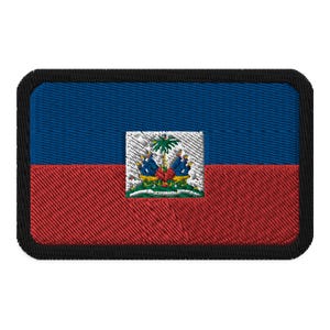 May include: A rectangular embroidered patch featuring the flag of Haiti. The flag is blue, red, and white with the Haitian coat of arms in the center.
