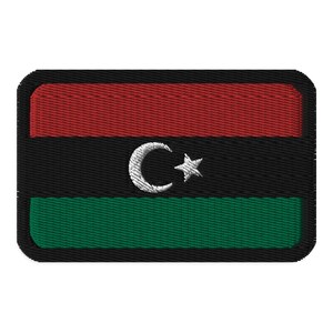 May include: A rectangular embroidered patch featuring the Libyan flag. The flag is green, black, and red with a white crescent moon and star in the centre.