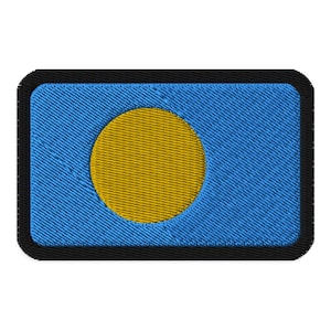 May include: Embroidered patch featuring the flag of Palau. The patch has a blue background with a yellow circle in the center-left and a black border. The flag design is stitched with detailed thread.