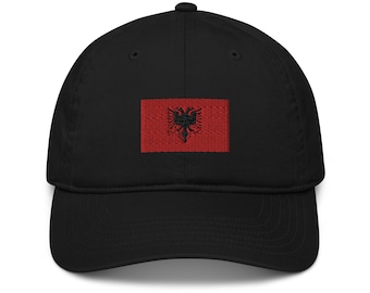 May include: Black baseball cap with a red embroidered patch featuring a black double-headed eagle on a red background. The cap is made of a soft material and has a curved brim. A stylish accessory for everyday wear.