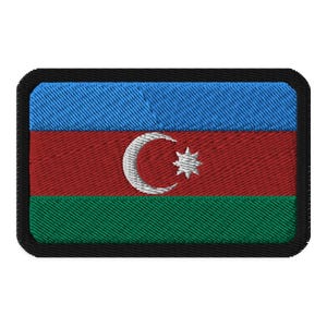 May include: An embroidered patch featuring the flag of Azerbaijan. The flag is a horizontal triband of blue, red, and green with a white crescent moon and star in the center.